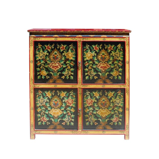 This is a medium-tall cabinet with colorful Tibetan style flower graphic at the front as a decorative accent. It can be a...