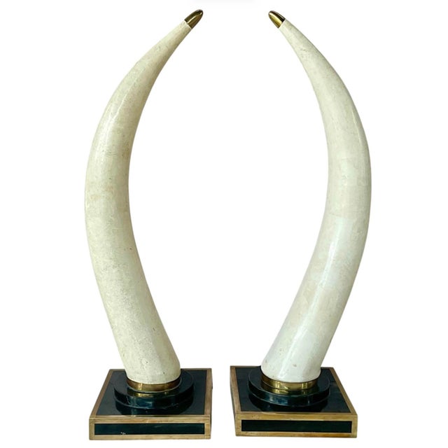 From Marquis Collection Beverly Hills is this glamorous Pair of Large Faux Tusk Sculptures on Black Faux Marble and Brass...