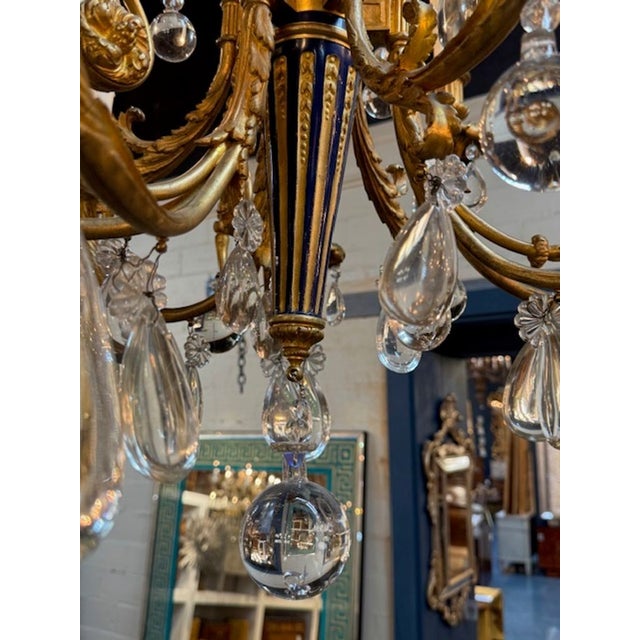 This 19th-century French Louis XVI gilt bronze and blue enamel chandelier exudes elegance and sophistication. The...