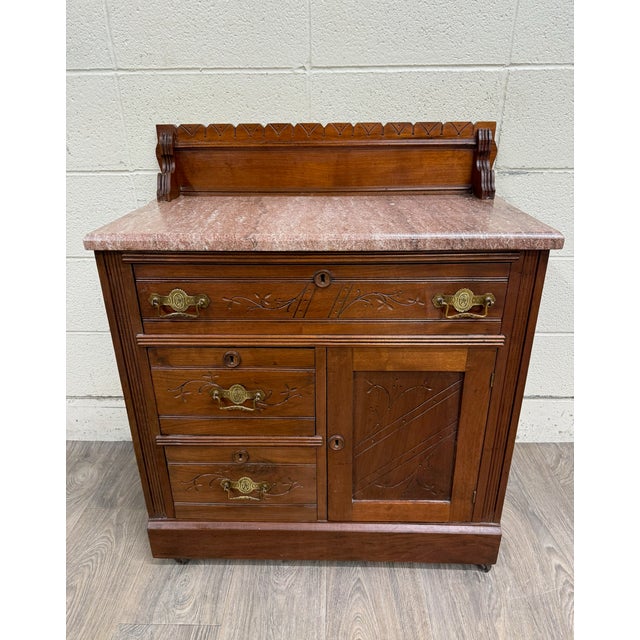 This is a beautiful antique late 1800s Victorian Eastlake style walnut and marble top cabinet, commode, or washstand with...