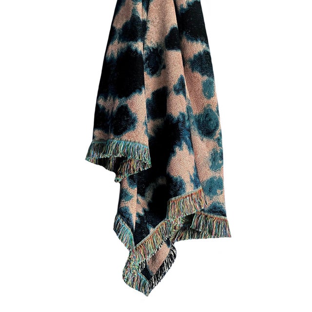 Rose pink and indigo blue jacquard woven throw with fringed edges. Woven with recycled cotton on a jacquard loom, made in...