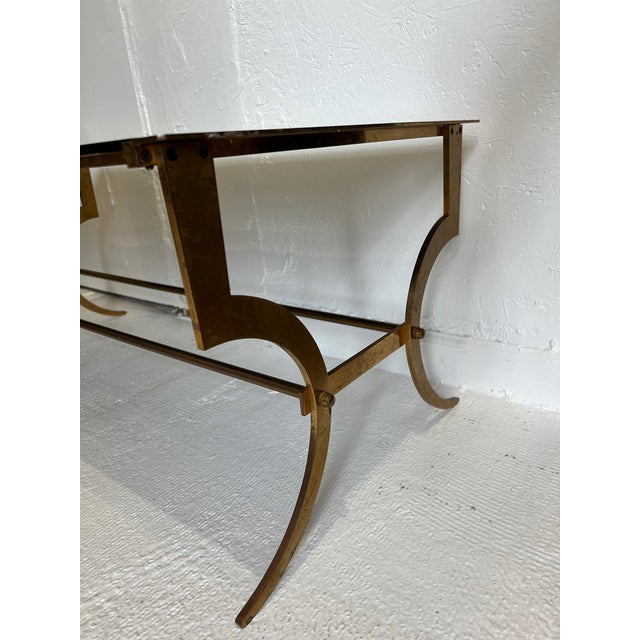 This French gilded wrought iron coffee table in the style of the Parisian design house of Maison Ramsey would look equally...