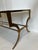This French gilded wrought iron coffee table in the style of the Parisian design house of Maison Ramsey would look equally...