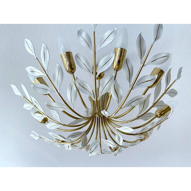 Large mid century pendant light featuring 10 brass curved spokes adorned with white leaves and handpainted gold highlight...
