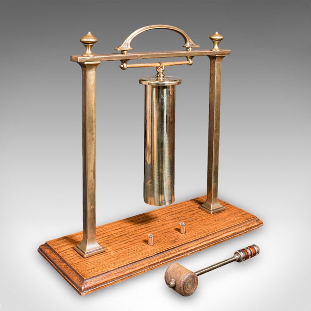 This is an antique veranda supper bell. An English, brass and oak afternoon tea gong, dating to the Edwardian period,...