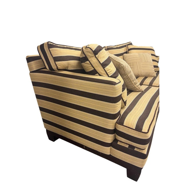 Unmarked Burton James cutomized sofa with brown and cream stripes, dark wood feet, and matching throw pillows.