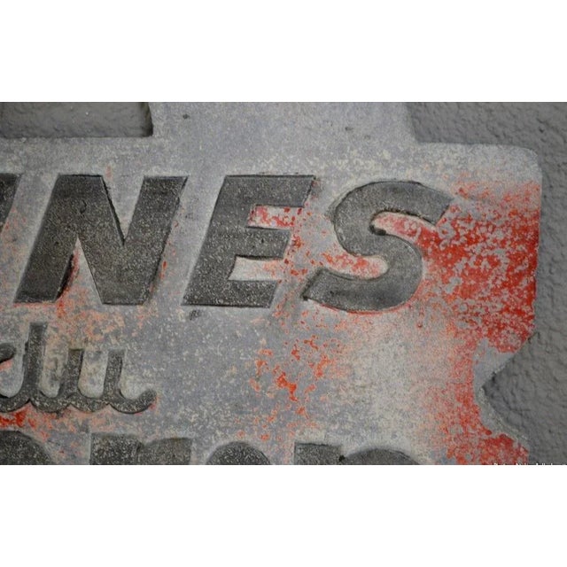 This vintage double-sided shop sign is enameled and molded. It features 1940s typography advertising "Les Laines du Marin".