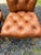 Set of 4 luxurious tufted slightly distressed supple brown leather dining chairs having turned light wood legs and brass...