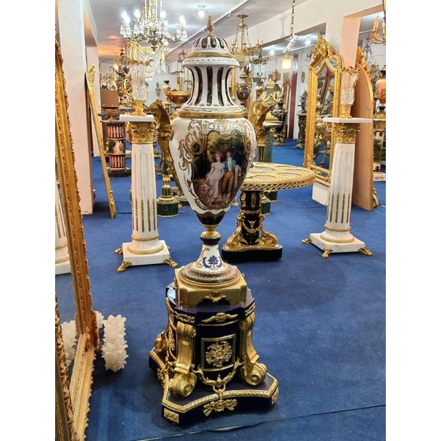 This monumental Baroque-style porcelain vase is an extraordinary decorative statement piece finished in rich white tones...