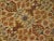 Intricate floral pattern in golden tone. Wool pile on cotton foundation. Extra wide main border displaying stylized...