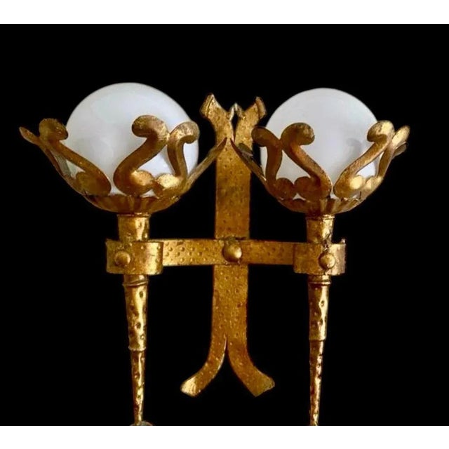 Gothic revival gold leaf gilt wrought iron double wall light with two opaline glass globe shades, spain, 1950s. This torch...