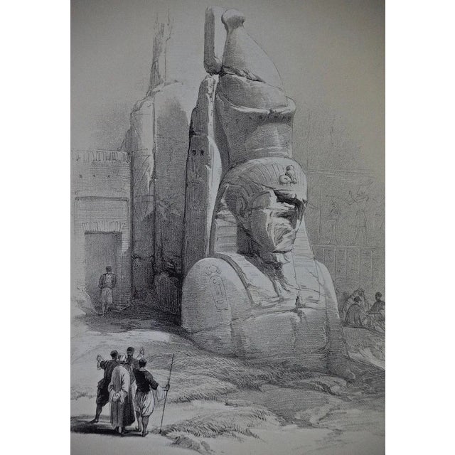 "One of Two Colossal Statues of Rameses II. Entrance to the Temple at Luxor" is a 19th century half-folio sized duo-tone...