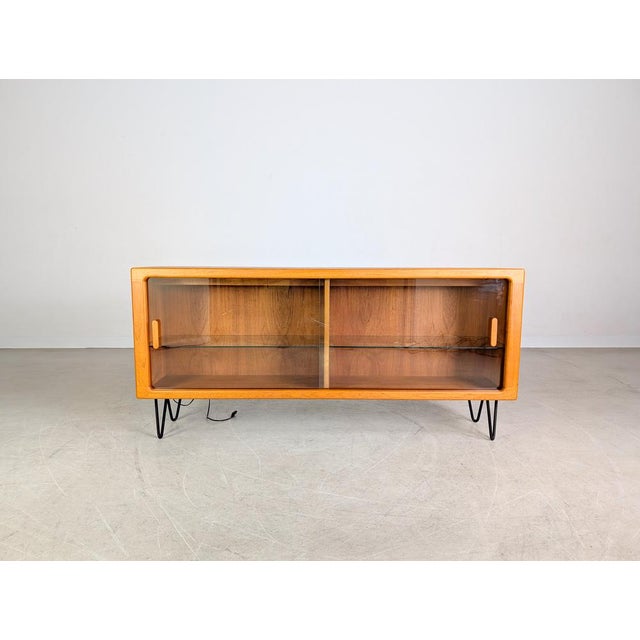 Beautiful teak sideboard with glass doors by c. F. Christensen silkeborg from the 1960s for sale. The piece features two...