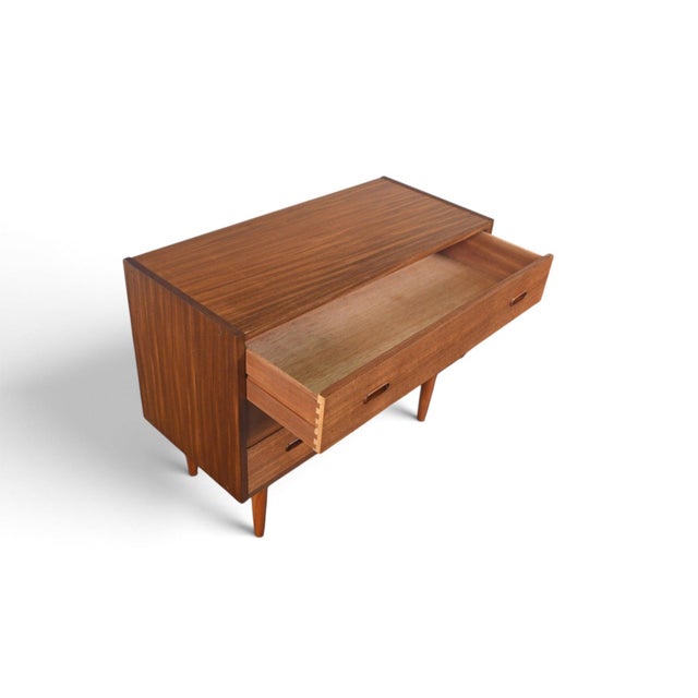 This three-drawer chest is styled in the manner of Arne Vodder, with a finished back that allows it to float freely in a...