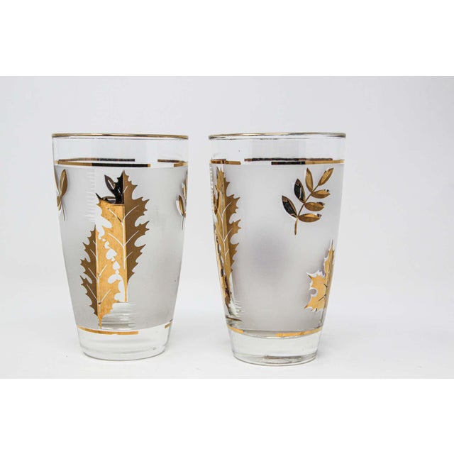 Set of two vintage cocktail glasses. Manufactured by Libbey. 1950s Hollywood Regency. Decorated with a classical gold lief...