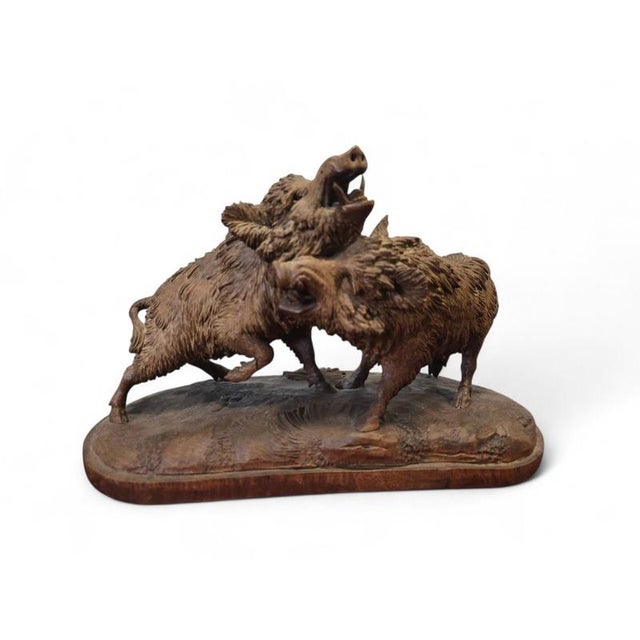 Rare and expressive 19th-century carved wooden sculpture depicting two warthogs, executed in the celebrated Black Forest...