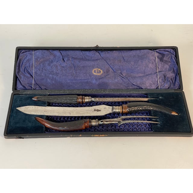 3 piece English antique stag horn set in original box by Christopher Johnson Sheffield. Comprises a serving knife, fork...