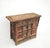 This antique cabinet is made from solid elm wood, showcasing a rich, warm grain and a beautifully aged patina. The piece...