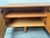 A fabulous Italian C1960s four doors credenza in oak wood resting on four cylindrical wooden legs to the base . The front...