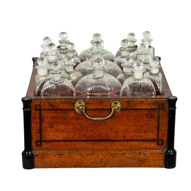 Square form with reeded corner columns and string inlaid case with brass carrying handles, fitted with seventeen original...