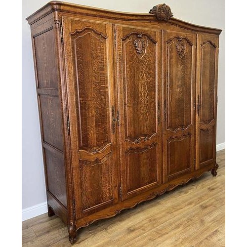 This elegant Vintage French Louis wardrobe showcases refined craftsmanship with beautifully carved panels, graceful...