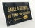 Vintage French commercial sign made of composite with a black background and yellow lettering. The sign reads "Salle...