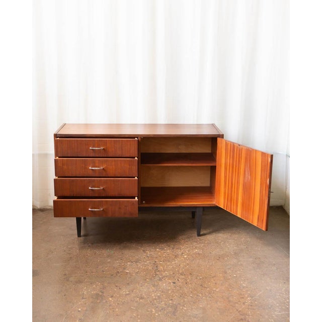 A well-proportioned Polish mid-century credenza in warm mahogany, produced in the 1970s during a period when Eastern...