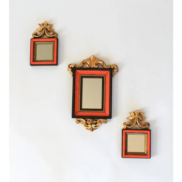 Set of three orange, brown and gold giltwood accent mirrors. Made in Italy. Ready to hang. Minor age wear. Large, 9"W x...