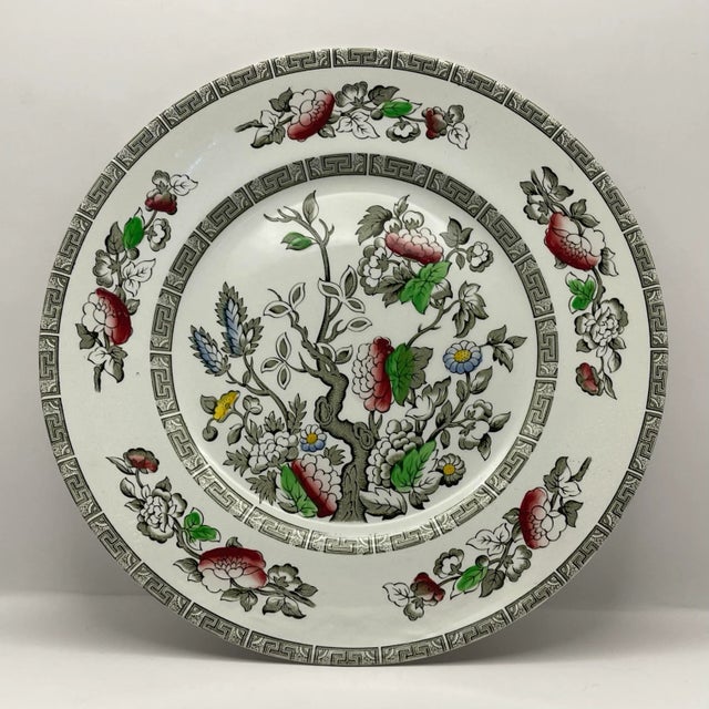 A version of the classic pattern with a double gray geometric border with a floral tree at the center and outer rim of...