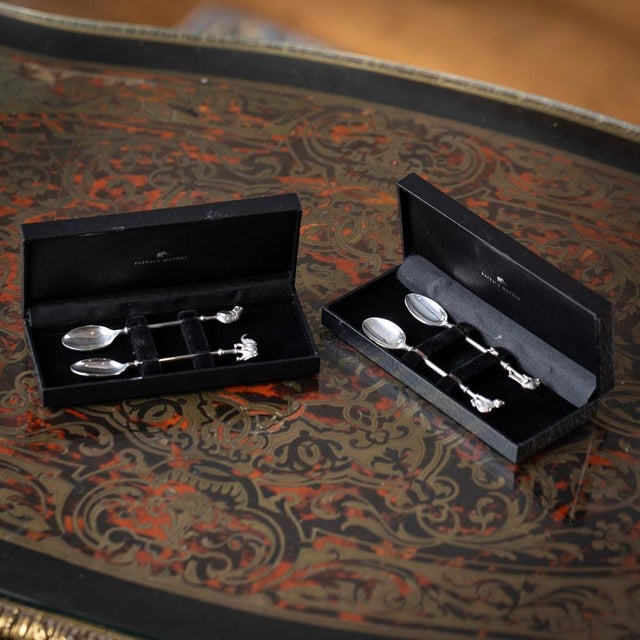 A set of four patrick mavros solid silver coffee spoons, each topped with a finely cast figure of an african animal: a...