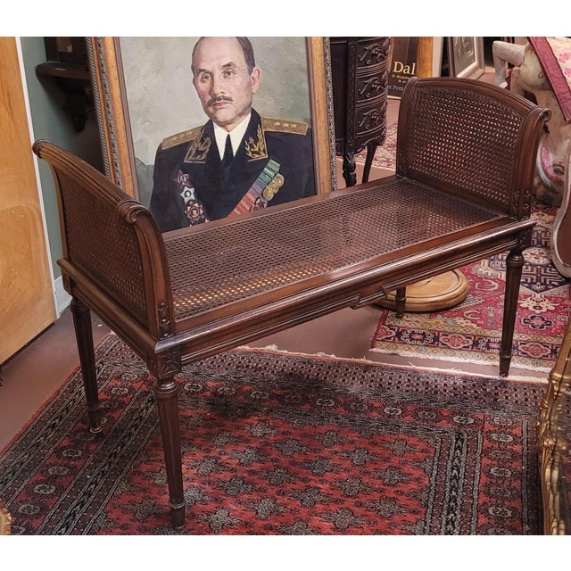 Find antique Georgian Style cane window bench. Features double caning on each side in a dark walnut finish. Fluted legs...