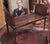 Find antique Georgian Style cane window bench. Features double caning on each side in a dark walnut finish. Fluted legs...