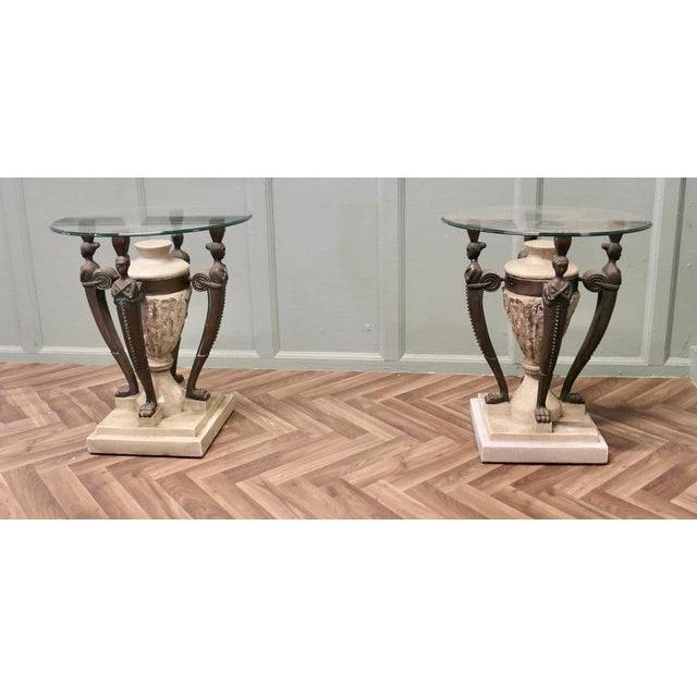 A Pair of Italian Classical Style Side Tables The tables are finished in simulated marble and bronze and is designed in a...
