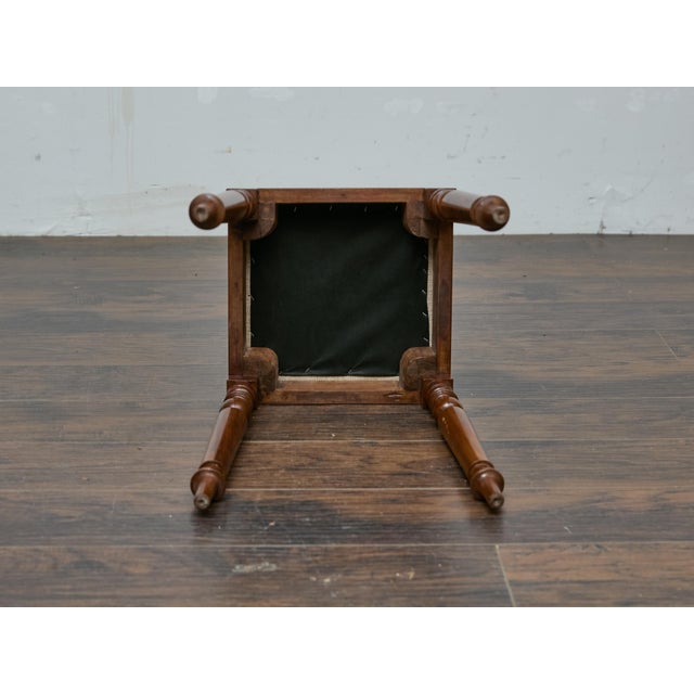 This English mahogany stool, crafted in the 19th century, is a testament to the refined craftsmanship of the period. The...