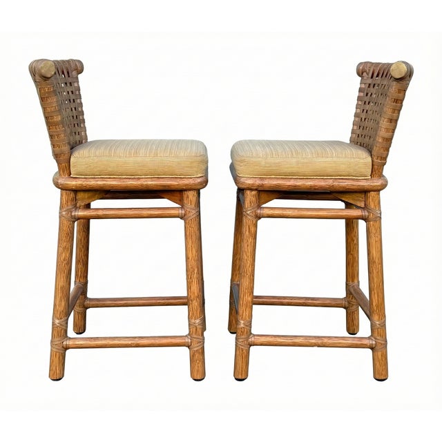 Presenting a beautiful pair of vintage stools by the renowned McGuire Furniture Company, epitomizing relaxed California...
