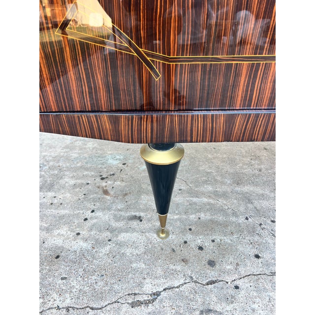 Striking French Art Deco sideboard featuring dramatic bookmatched Macassar ebony veneer throughout, accented by elegant...