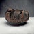 Japanese bamboo ikebana basket dating to the Showa period, circa 1940s–1970s. Handwoven from split bamboo with a smoked...