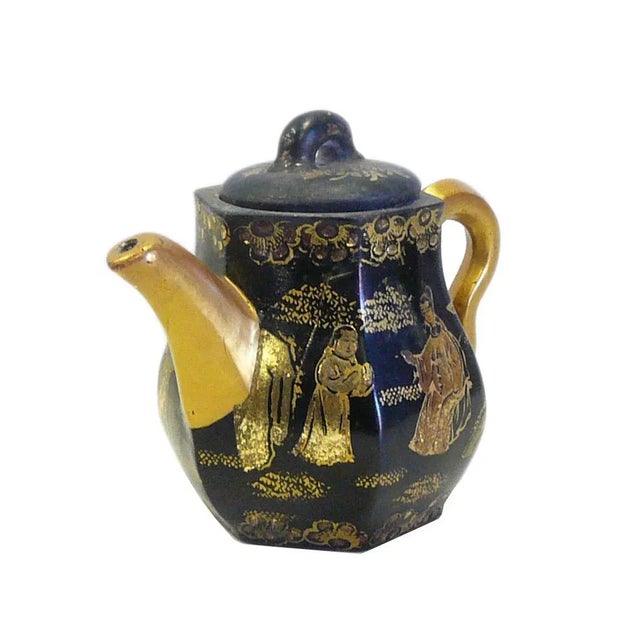 This is an art work display of oriental Chinese teapot which is made of Zisha clay and hand painted with golden color...
