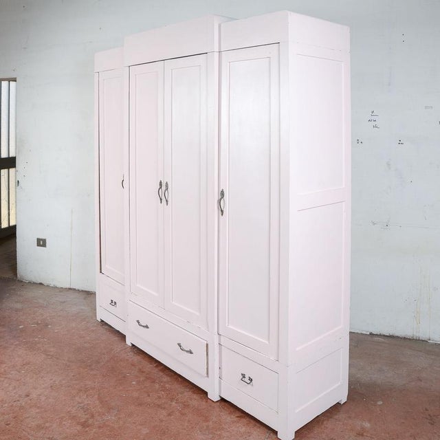 This spacious four-door wardrobe, dating from the first half of the 20th century, represents an interesting fusion of...