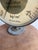 An authentic mid-century industrial pressure gauge featuring a large circular dial housed in a heavy steel casing....