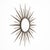 Striking French Mid-Century Modern sunburst mirror, circa 1960, handcrafted from embossed and hand-hammered metal....