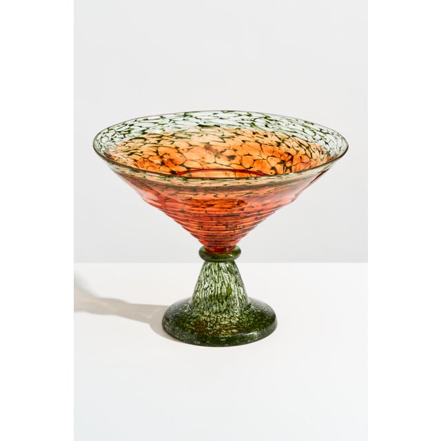 Designed by Kjell Engman for Kosta Boda, this substantial Swedish blown glass pedestal bowl features a broad flared basin,...