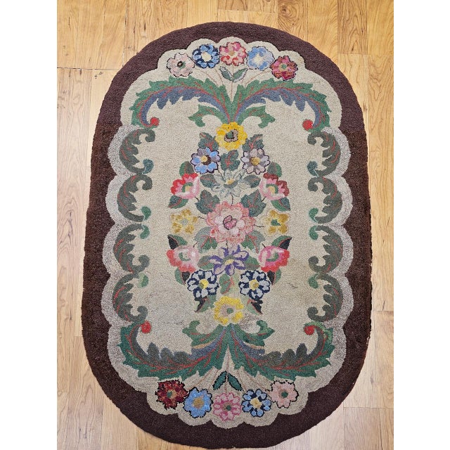 This beautifully preserved Vintage American hand-hooked rug, crafted in the early 1900s in the New England region, is a...
