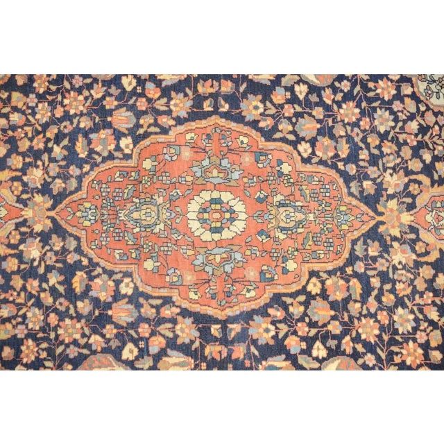 An exceptional late 19th century Persian Sarouk Farahan rug with a wonderful large crimson medallion woven with a tight...