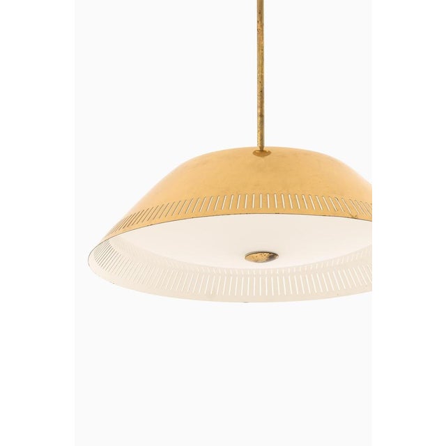 The ceiling lamp model 61-103, designed by lisa johansson-pape and produced by stockmann-orno in finland during the 1950s,...