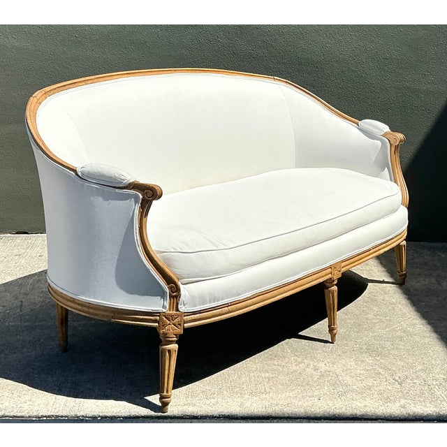 This exquisite French Louis XVI style canapé is a masterclass in Neoclassical elegance and artisanal craftsmanship. The...