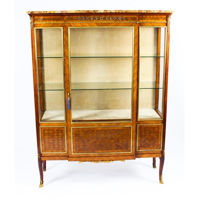 This is a beautiful antique French Louis Revival parquetry and ormolu mounted breakfront vitrine, circa 1860 in date. This...