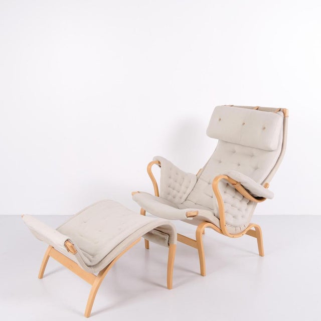 Pernilla armchair with matching footstool, model 69, designed by bruno mathsson and produced by dux as a 35th anniversary...