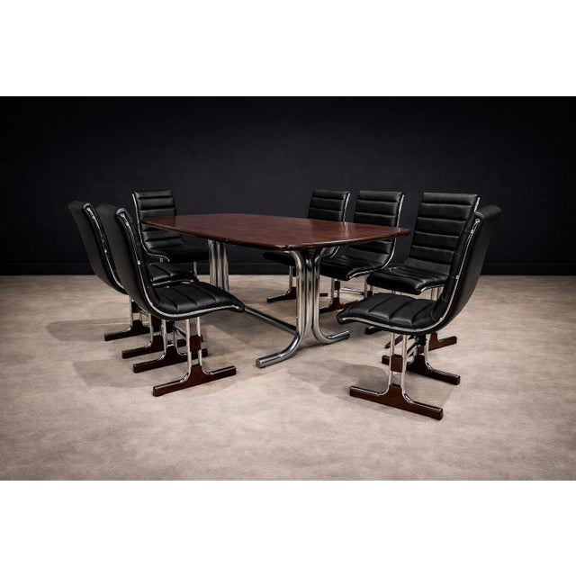 This set of six dining chairs reflects a disciplined exploration of material contrast and structural precision...