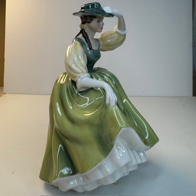 This vintage Royal Doulton “Buttercup” figurine (HN2309) is a graceful example of mid-century English bone china from the...